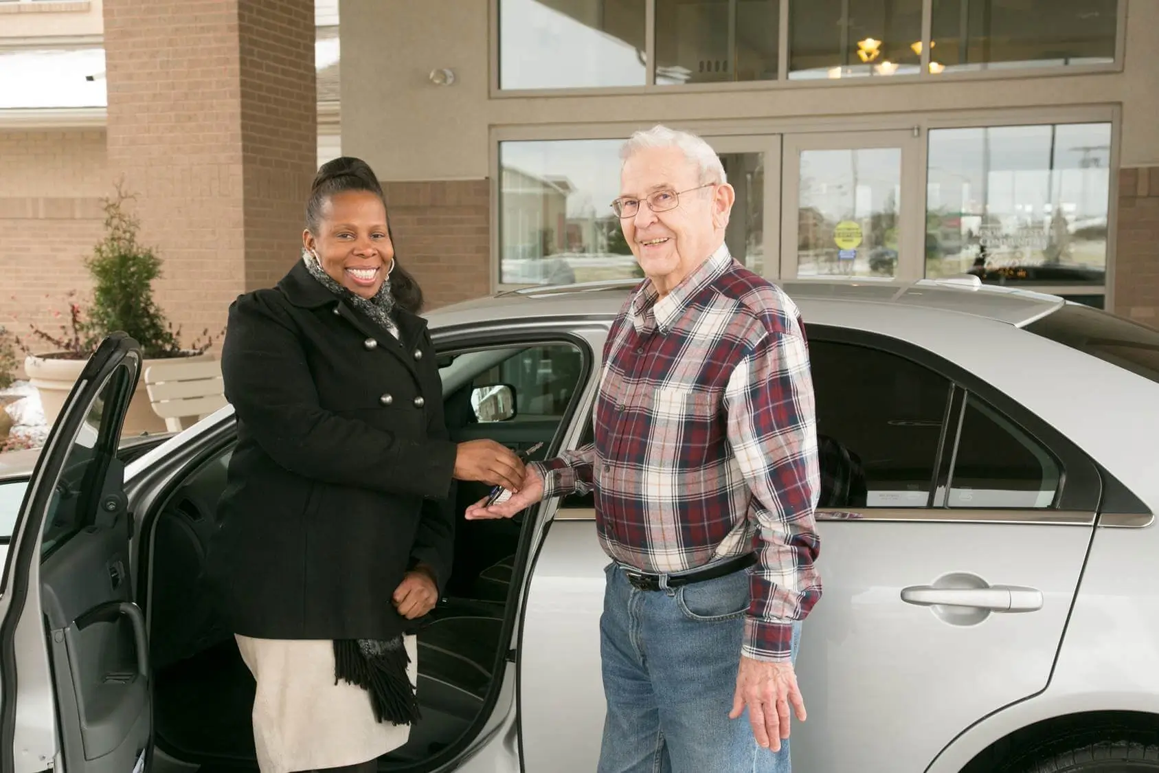 RLC team member handing keys to RLC resident