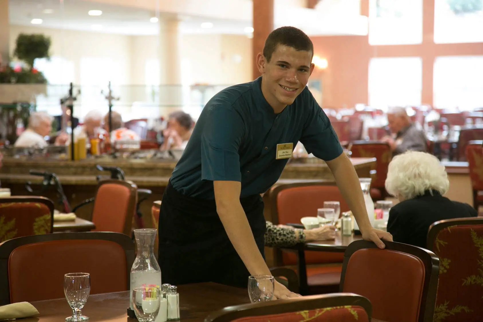 RLC team member busing table in RLC community dining area